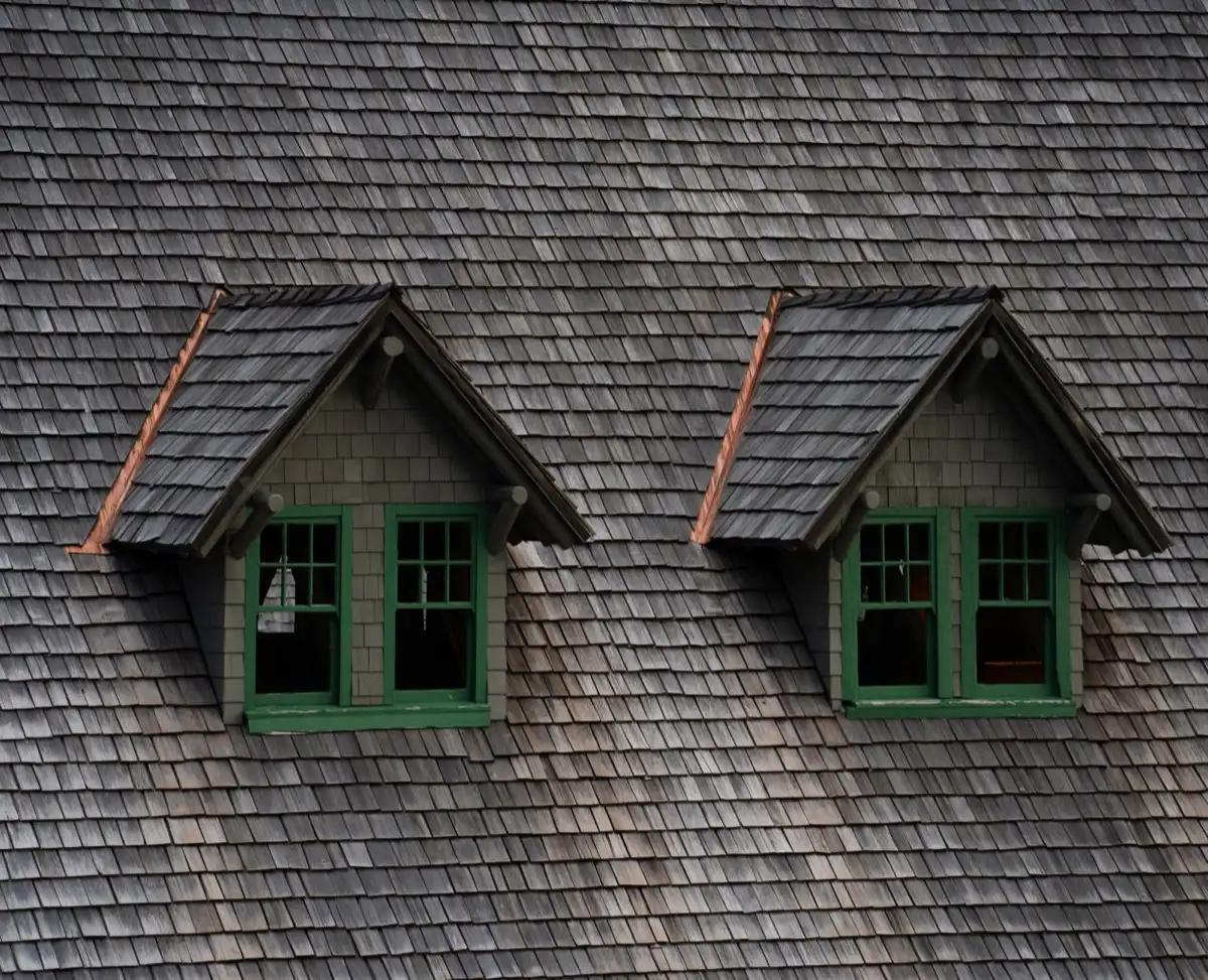 Dormers on a shingle roof in Brownsville, TX, where step flashing and kickout flashing carry water past the walls